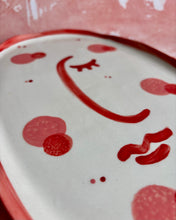 Carica l'immagine nel visualizzatore di Gallery, Ceramic plate with red abstract design on a white background