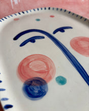Carica l'immagine nel visualizzatore di Gallery, Decorative ceramic plate with blue and pink abstract designs on a white background