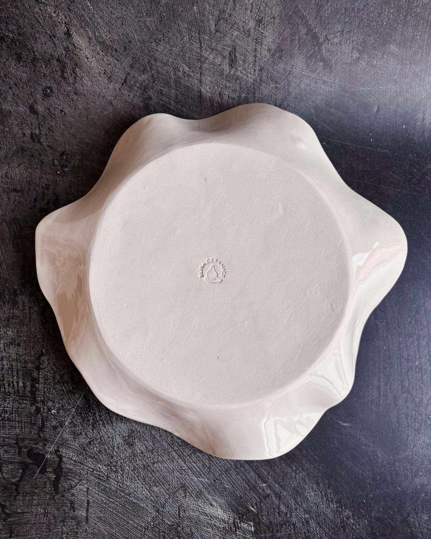 Bottom of a ceramic bowl showing the brand of Elisa Ceramics
