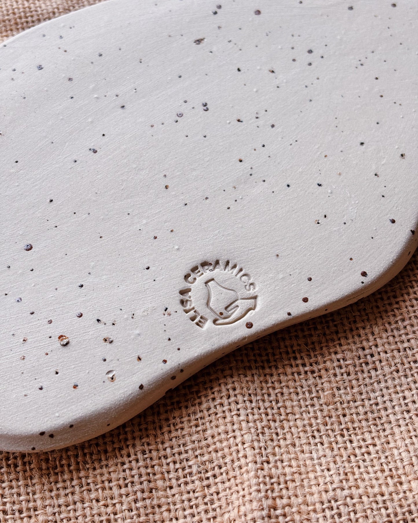 Close-up of a speckled gray insole with a logo on a textured brown surface