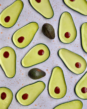 Load image into Gallery viewer, Colorful avocado spoon rest design featuring handmade stoneware with red detailing.