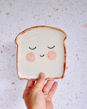 Load image into Gallery viewer, Handmade Mr Bready Spoon Rest in the shape of a smiling slice of bread, perfect for fun kitchen decor.