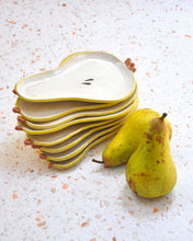 Load image into Gallery viewer, Set of Pear Spoon Rests stacked beside fresh pears, showcasing handmade stoneware, ideal for kitchen decor.