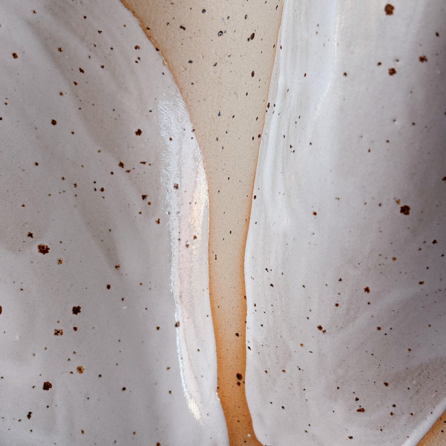 Close-up of a dessert with white cream and brown specks on a beige background