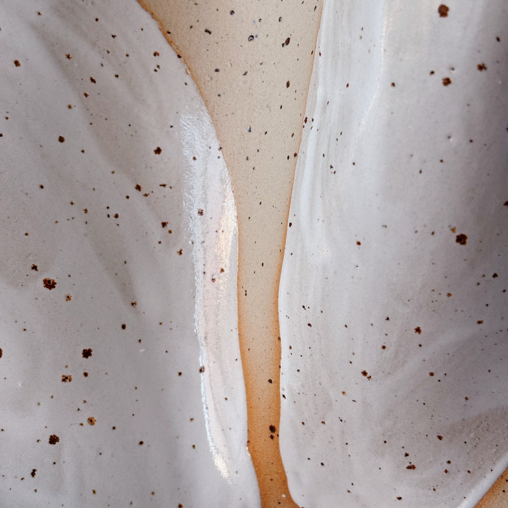 Close-up of a dessert with white cream and brown specks on a beige background