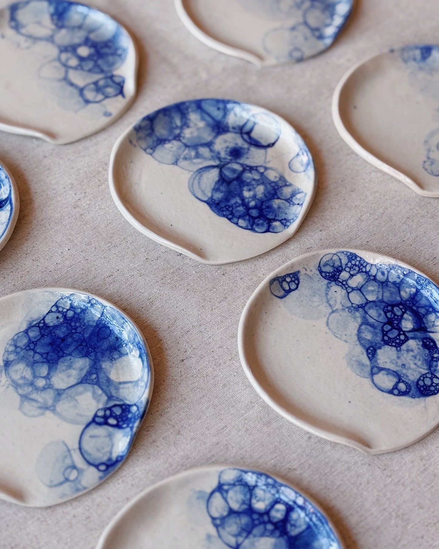 Set of ceramic plates with blue abstract patterns on a light background