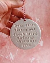 Carica l'immagine nel visualizzatore di Gallery, A hand holding a Christmas decoration on a pink background
