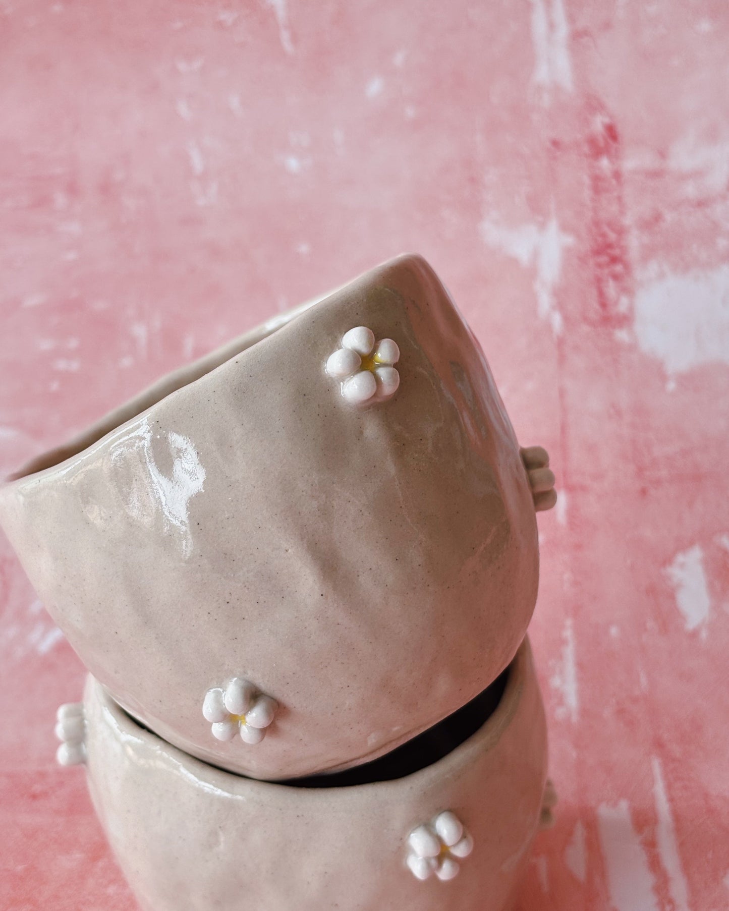 Handmade ceramic mug with ceramic daisies applied to