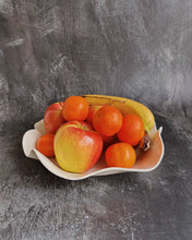 Carica l'immagine nel visualizzatore di Gallery, A ceramic bowl holding some tangerines, bananas and apples on a black background
