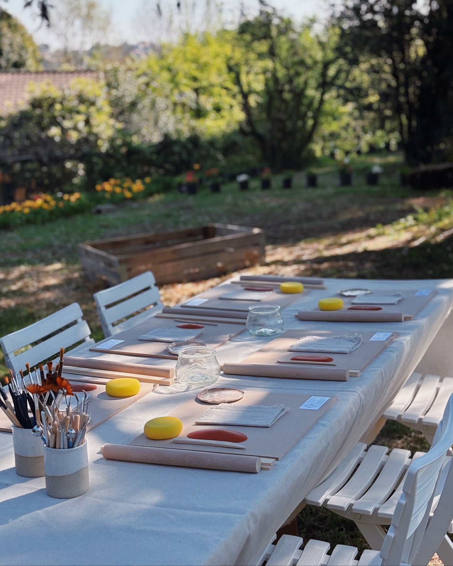 A table set up for a cerami workshop in a garxen