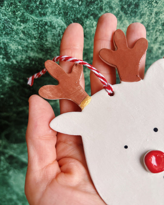 Kintsugi Rudolph Reindeer - Limited Edition, handmade reindeer decoration held in hand with red and white string.