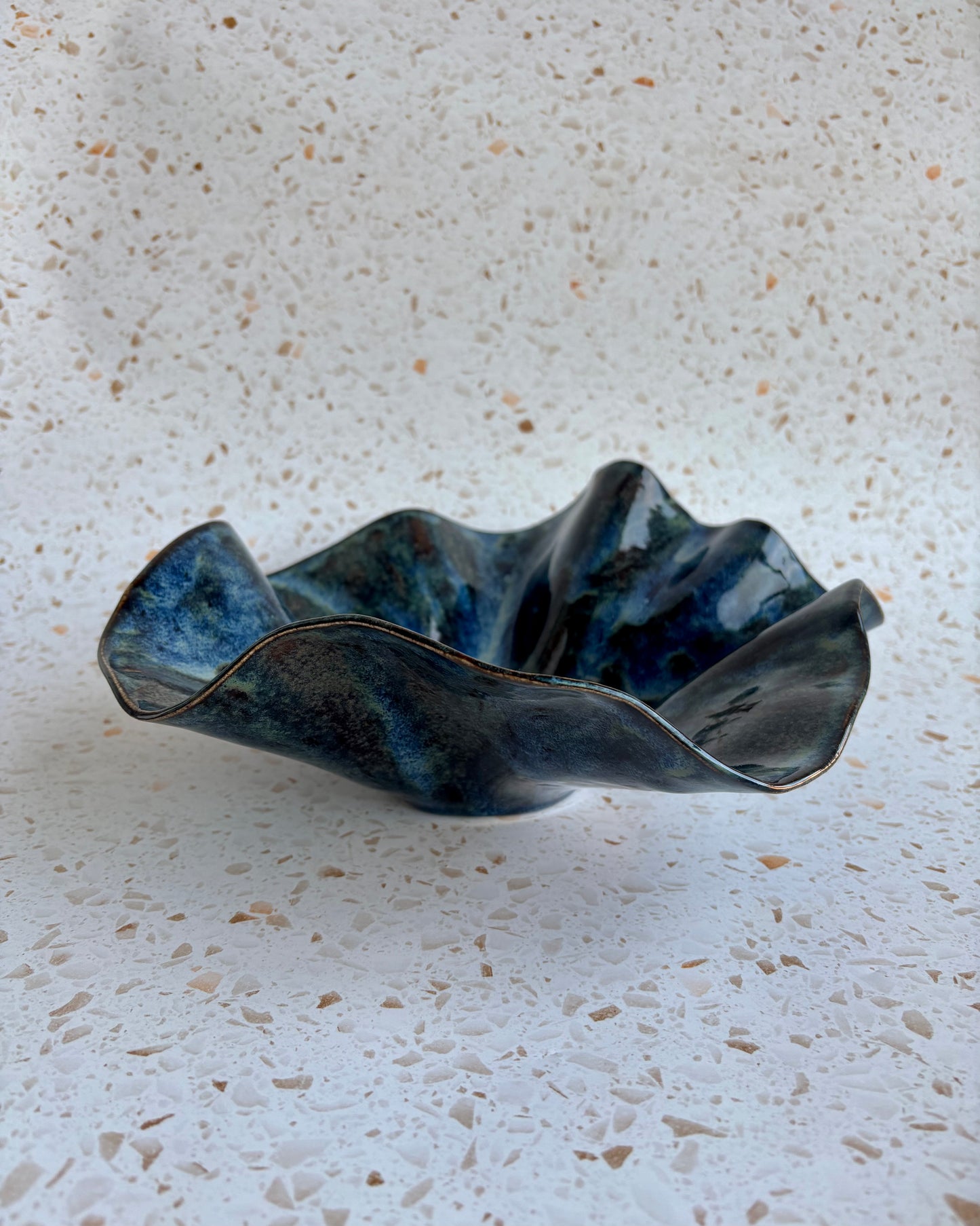 Unique Mercury Bowl, handmade stoneware ceramic, ideal for fruits, featuring ruffled edges and vibrant colors.