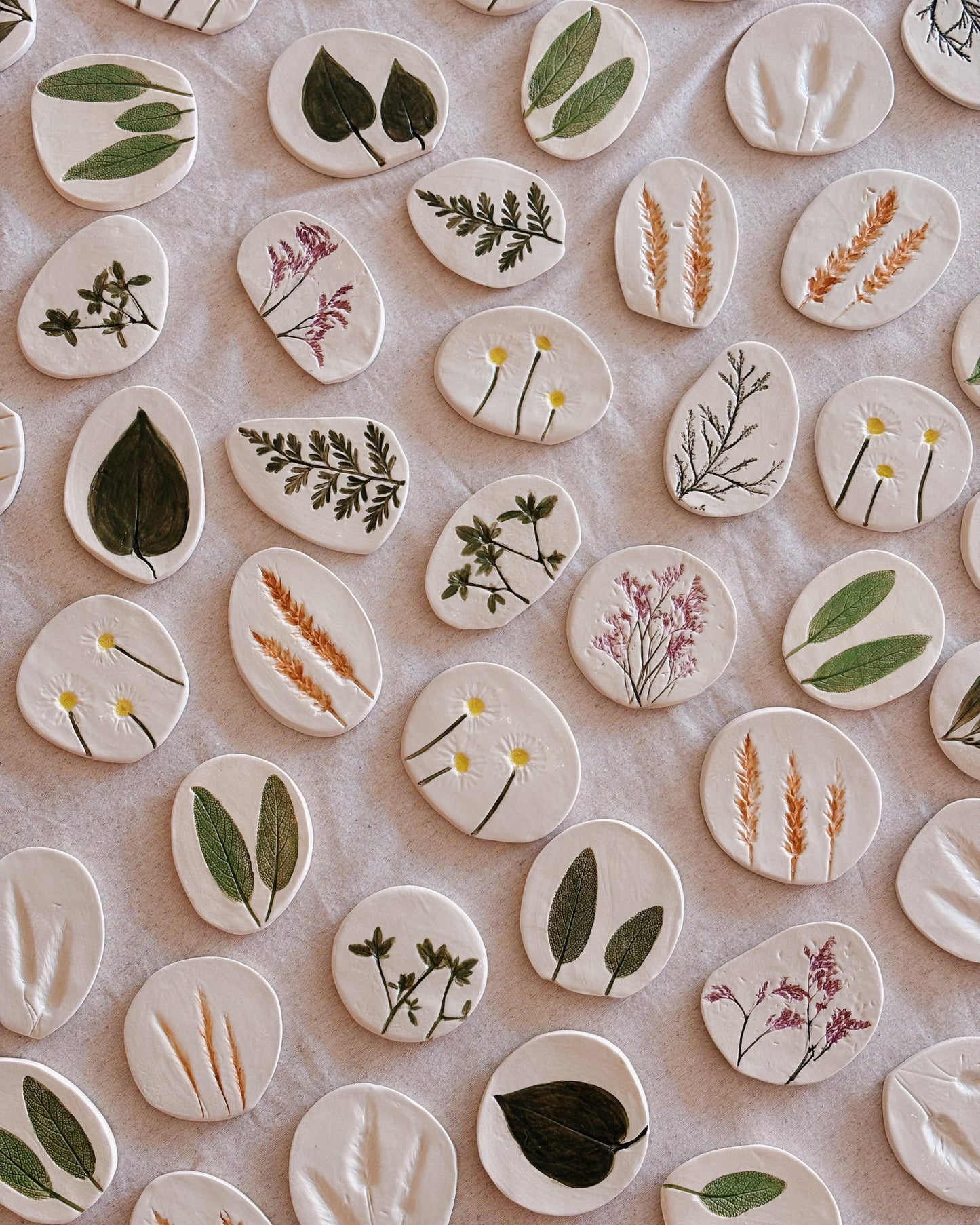 Decorative ceramic tiles with plant designs on a beige background