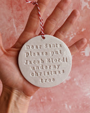 Carica l'immagine nel visualizzatore di Gallery, A hand holding a Christmas decoration on a pink background
