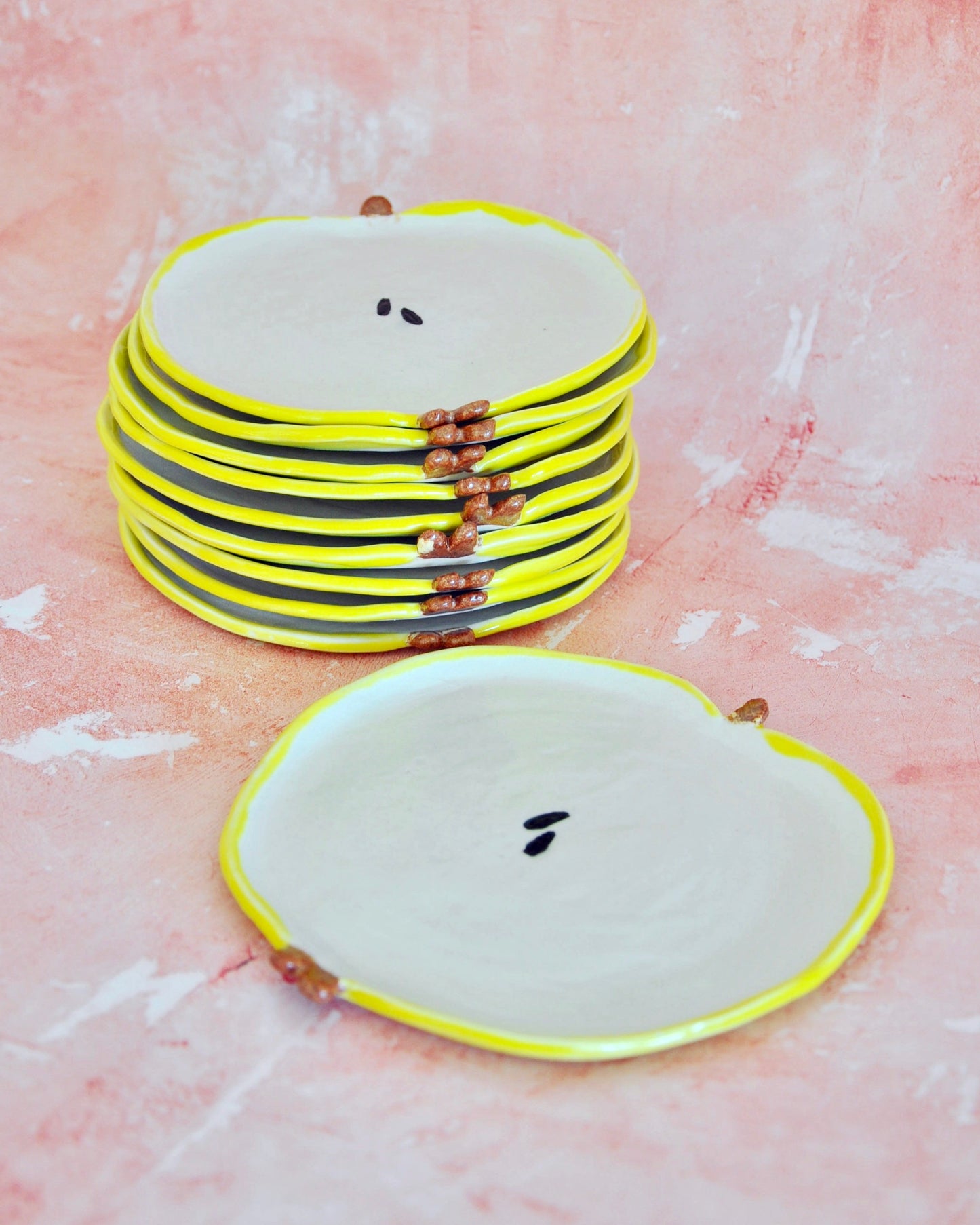 Handmade Apple Spoon Rest in stoneware, featuring a fun design with decorative yellow edges.