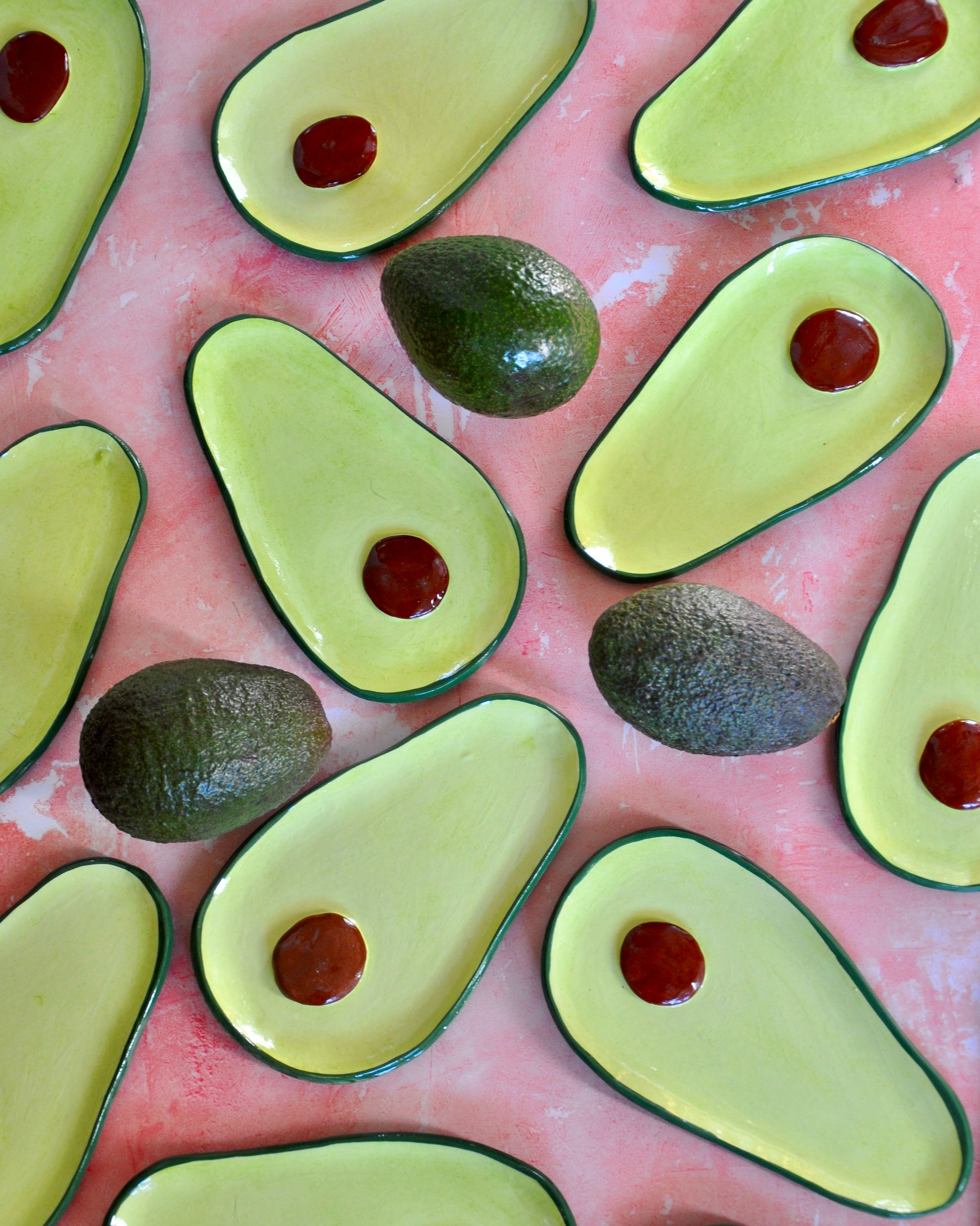 Avocado Spoon Rest arranged on a colorful surface, featuring handmade stoneware with a glossy finish and vibrant avocado design.