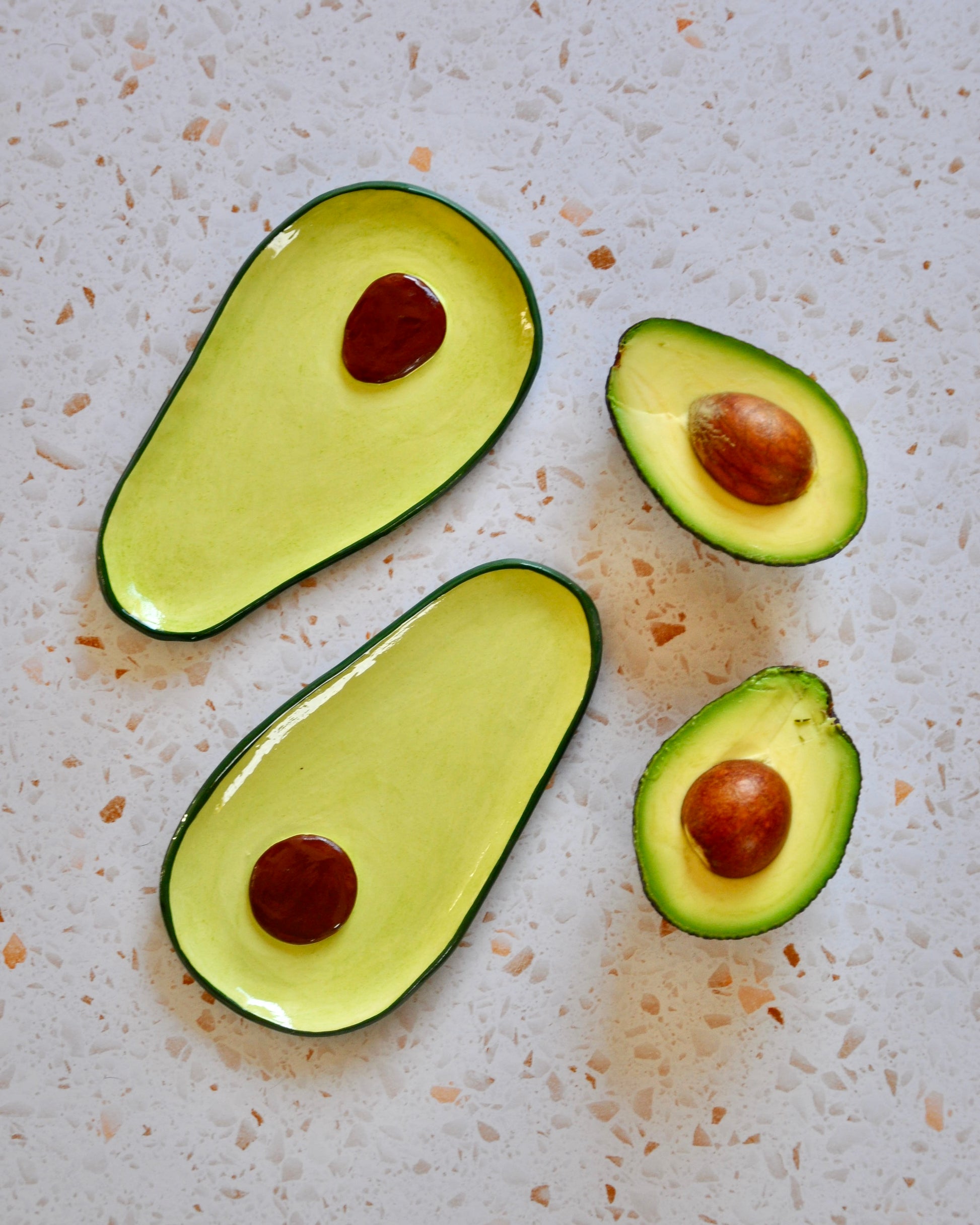 Avocado Spoon Rest featuring handmade stoneware in green and yellow hues, ideal for kitchen use.