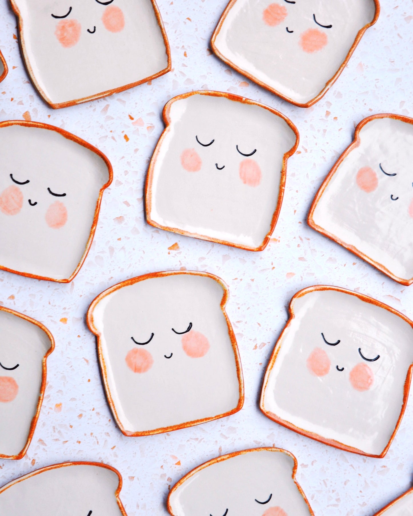 Mr Bready Spoon Rest - handmade stoneware spoon rests shaped like cute bread slices, ideal for kitchen decor.