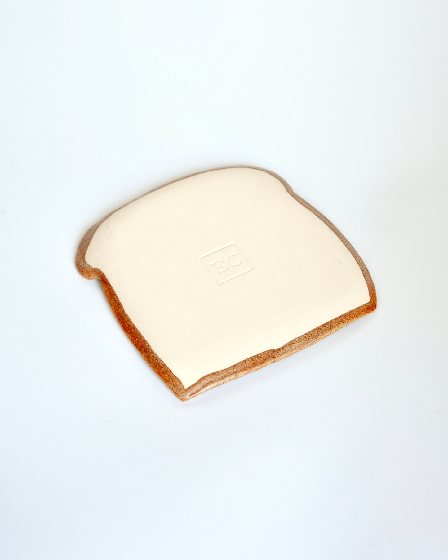 Mr Bready Spoon Rest, handmade stoneware spoon rest in the shape of a slice of bread, adding fun to your kitchen.